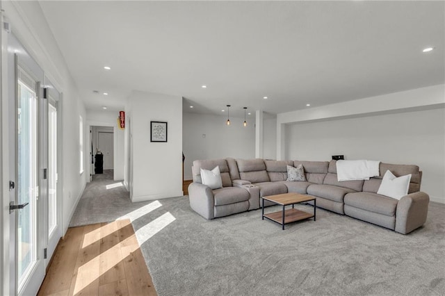 living area with recessed lighting and wood finished floors