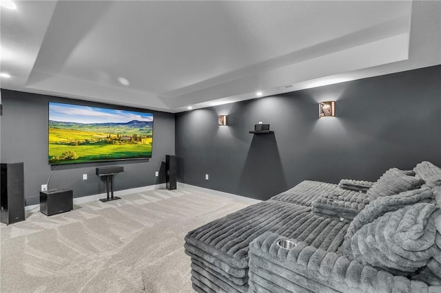 carpeted cinema with recessed lighting, a tray ceiling, and baseboards