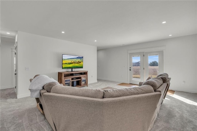 living area with recessed lighting, baseboards, and light carpet