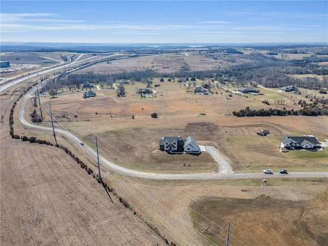 birds eye view of property with a rural view