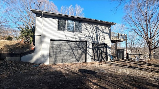 exterior space with an attached garage and dirt driveway