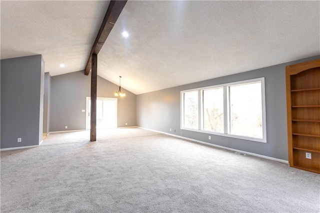 empty room featuring baseboards, visible vents, lofted ceiling with beams, a textured ceiling, and carpet floors