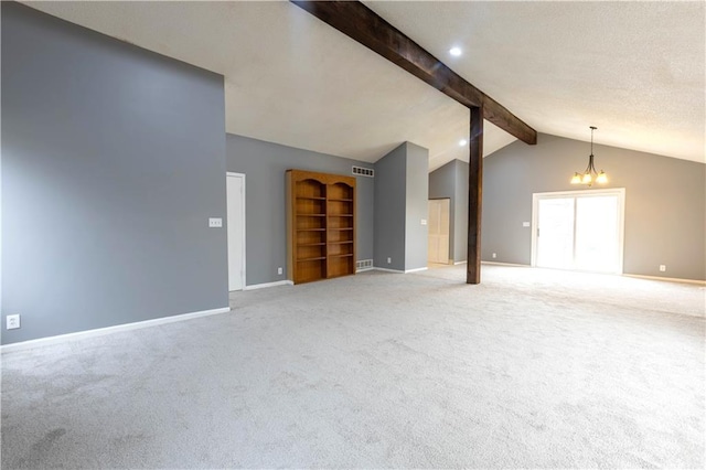 spare room featuring vaulted ceiling with beams, a notable chandelier, light carpet, visible vents, and baseboards