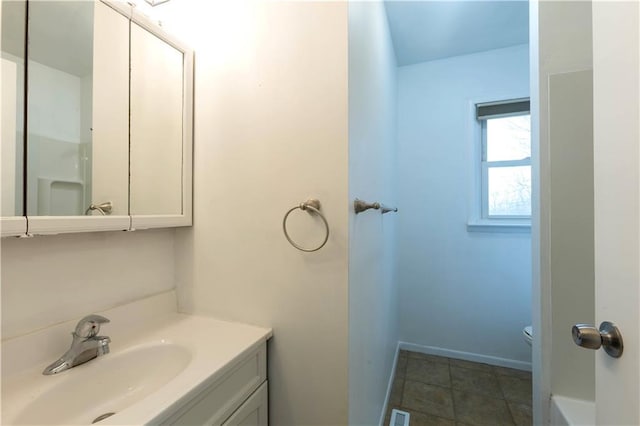 bathroom featuring visible vents, toilet, vanity, tile patterned flooring, and baseboards