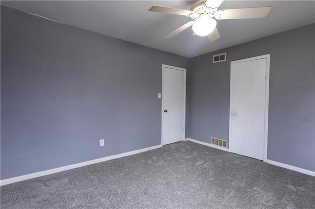 unfurnished room with ceiling fan, carpet flooring, visible vents, and baseboards