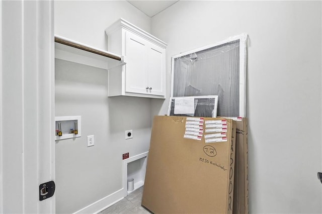 clothes washing area featuring washer hookup, cabinet space, hookup for an electric dryer, and baseboards