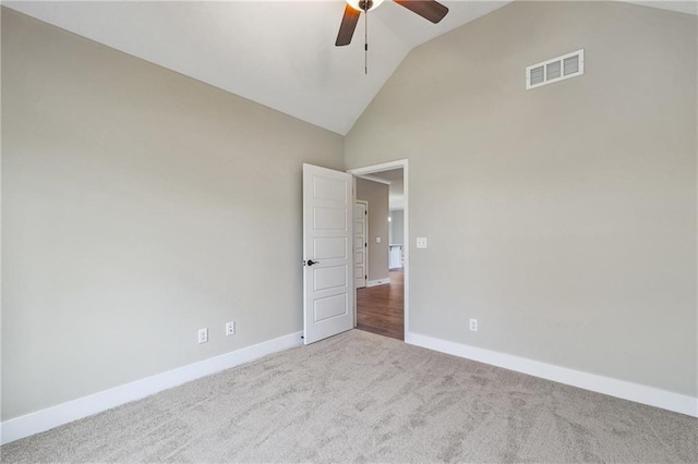 unfurnished room featuring carpet, visible vents, ceiling fan, high vaulted ceiling, and baseboards