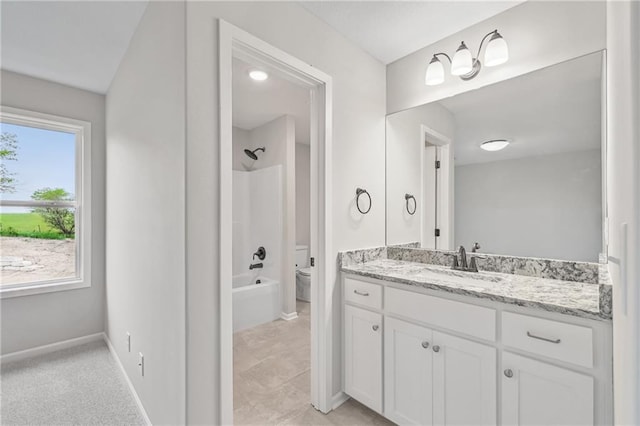 full bath featuring toilet, washtub / shower combination, baseboards, and vanity