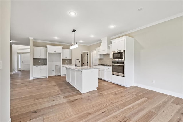 7005 NE 102nd Ct, Kansas City, MO 64156 - kitchen featuring appliances with stainless steel finishes, custom exhaust hood, ornamental molding, tasteful backsplash, and white cabinetry