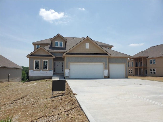 7005 NE 102nd Ct, Kansas City, MO 64156 - view of front of house with an attached garage, concrete driveway, and a shingled roof