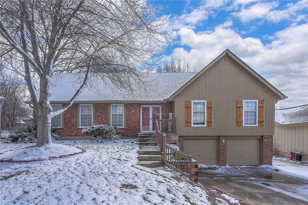 view of front of home featuring brick siding and an attached garage