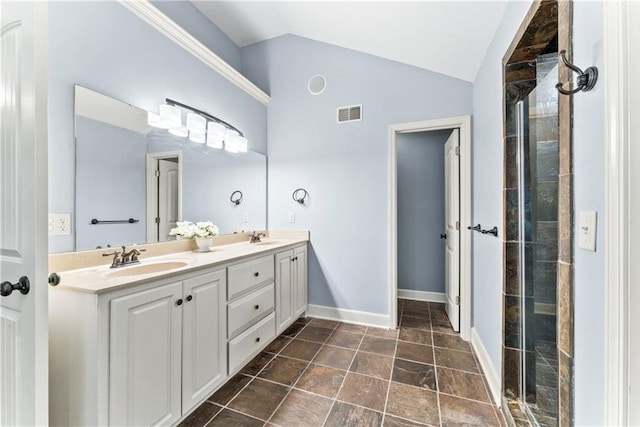 bathroom featuring a tile shower, visible vents, lofted ceiling, and a sink