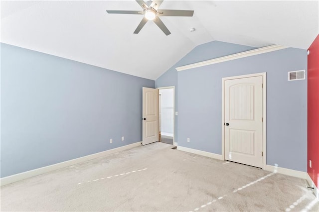 unfurnished bedroom featuring visible vents, baseboards, carpet floors, and vaulted ceiling