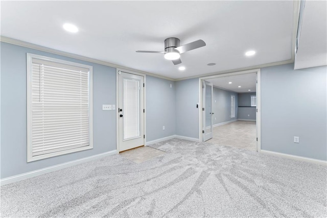 interior space featuring crown molding, carpet flooring, baseboards, and ceiling fan