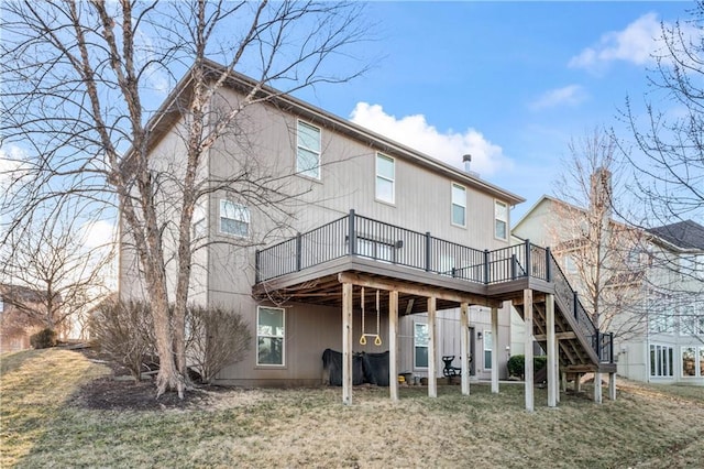 rear view of house with a wooden deck and stairs