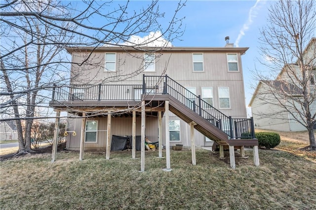 rear view of house with a wooden deck and stairs