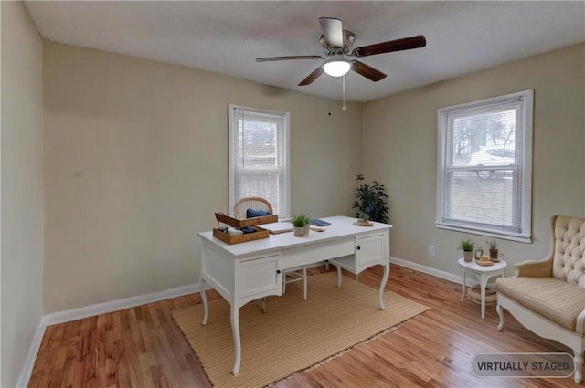 home office featuring ceiling fan, light wood-style flooring, and baseboards