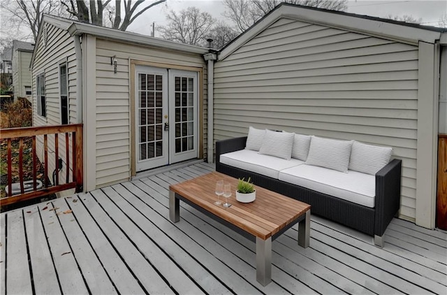 wooden deck with french doors and an outdoor living space