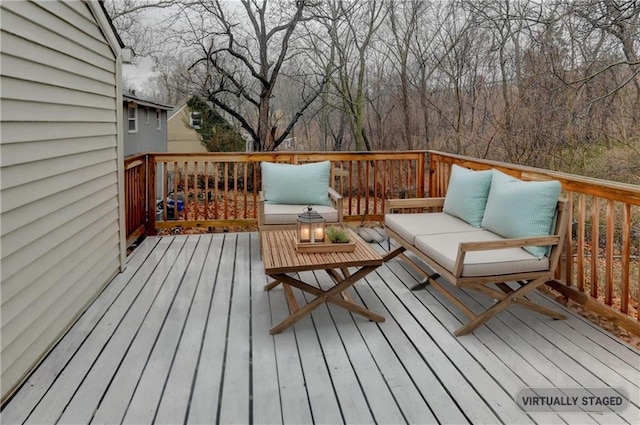 wooden terrace with an outdoor living space