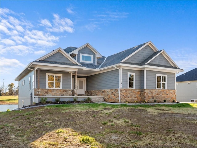 craftsman-style house featuring stone siding