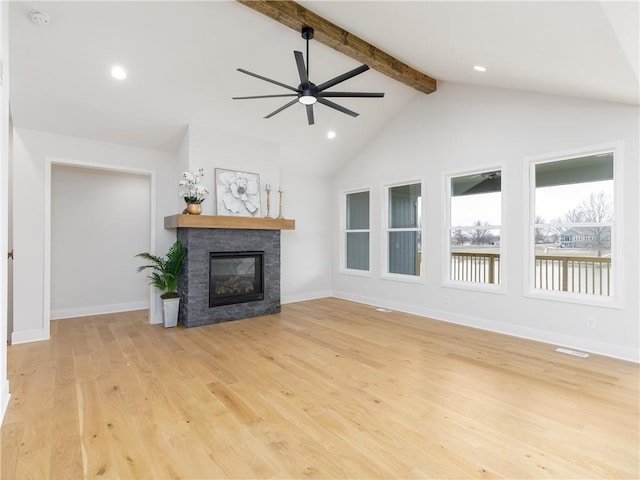 unfurnished living room with a stone fireplace, light wood-style flooring, vaulted ceiling with beams, and baseboards