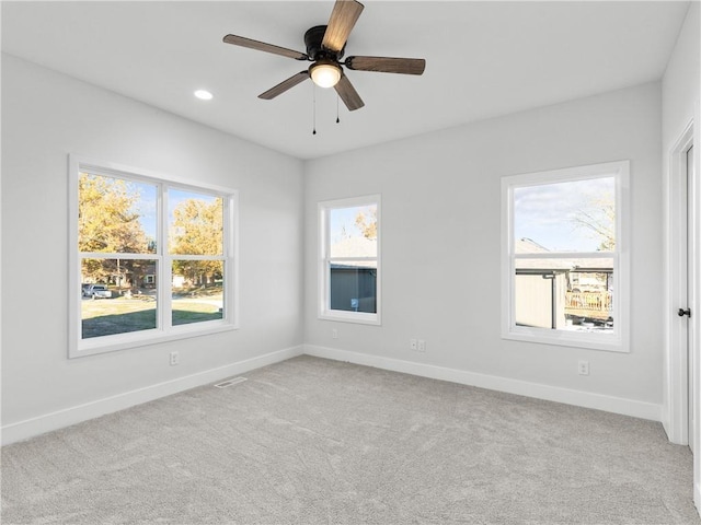 unfurnished room featuring light carpet, visible vents, recessed lighting, and baseboards