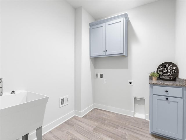 laundry area with a sink, electric dryer hookup, baseboards, and washer hookup