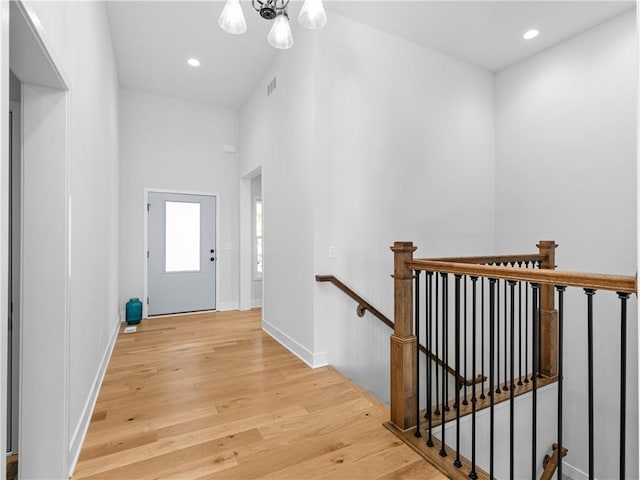 entrance foyer featuring visible vents, baseboards, recessed lighting, an inviting chandelier, and light wood-style floors