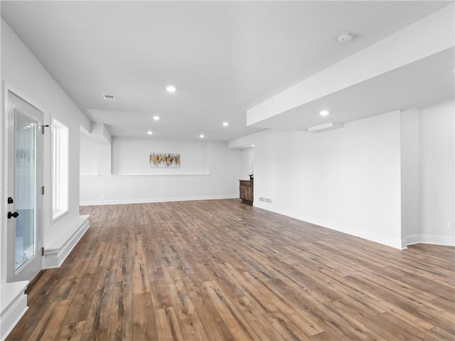 unfurnished living room featuring recessed lighting, visible vents, baseboards, and wood finished floors