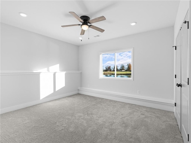 spare room with a ceiling fan, recessed lighting, carpet, and visible vents