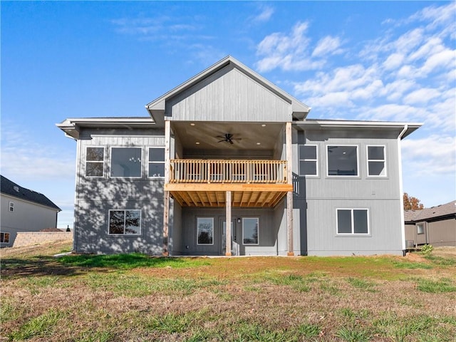 back of house with a yard, a balcony, and a ceiling fan