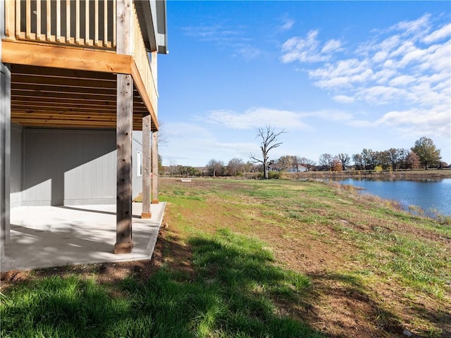 view of yard featuring a patio area and a water view