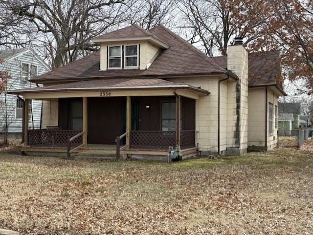 bungalow-style home with a porch, a chimney, and a shingled roof