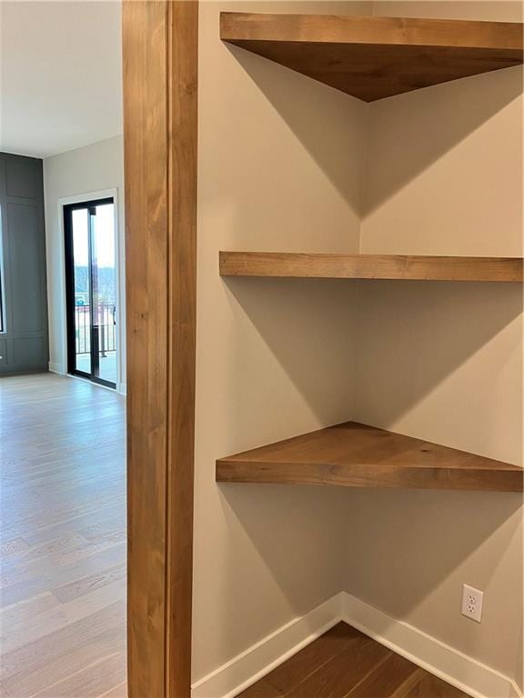 interior space featuring baseboards and wood finished floors