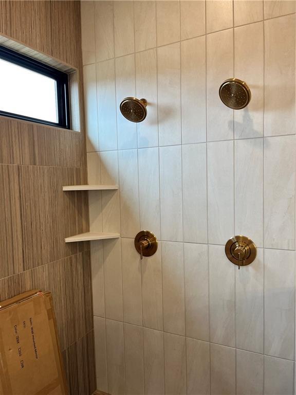 bathroom with tiled shower