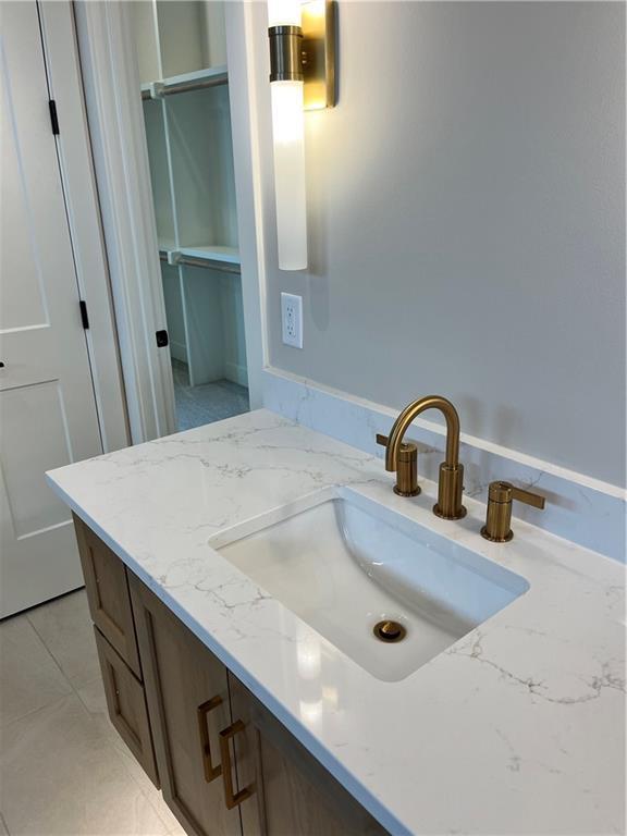 bathroom with vanity and tile patterned flooring