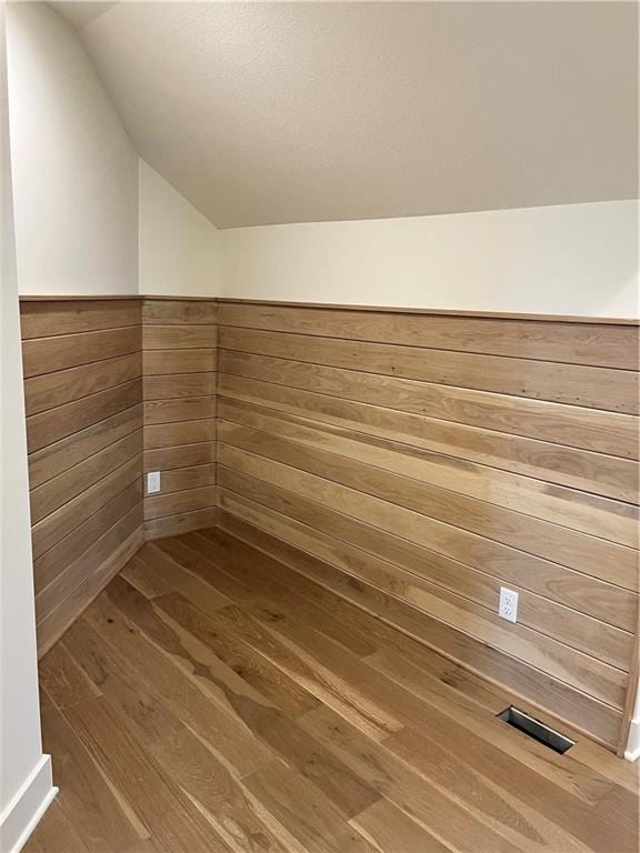 interior details with wood finished floors and wood walls