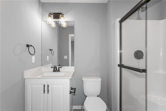 full bathroom with toilet, a shower stall, and vanity