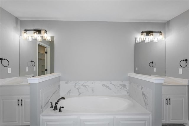 bathroom featuring vanity and a bath