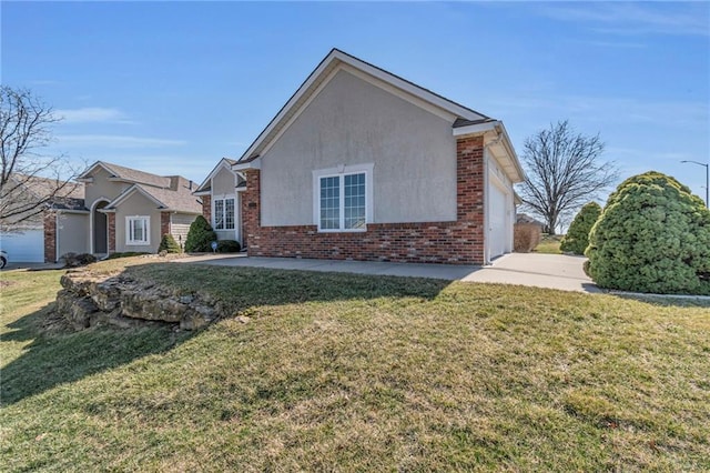 view of home's exterior featuring brick siding, stucco siding, and a yard