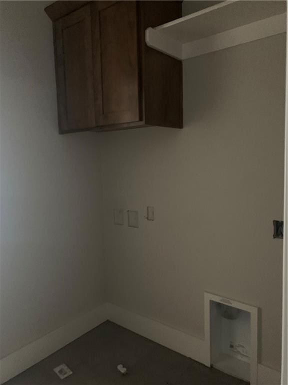 laundry room featuring baseboards, cabinet space, and washer hookup