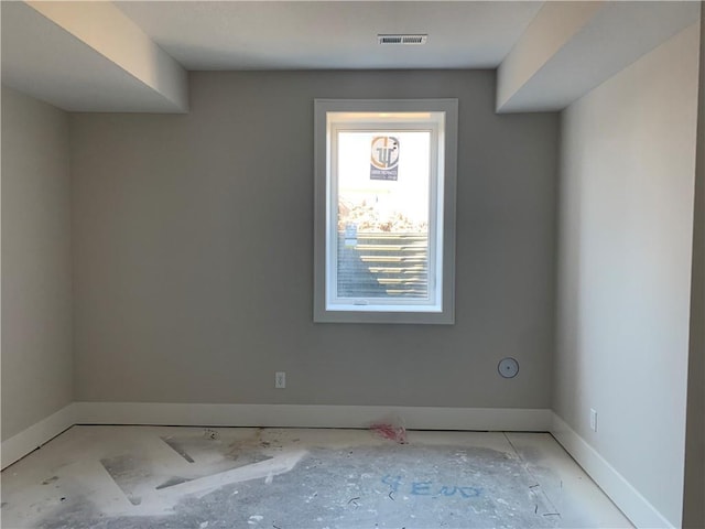 unfurnished room with visible vents and baseboards