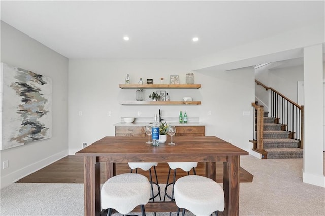 1510 NW 106th Ter, Kansas City, MO 64155 - dining space featuring stairway, baseboards, light carpet, and recessed lighting