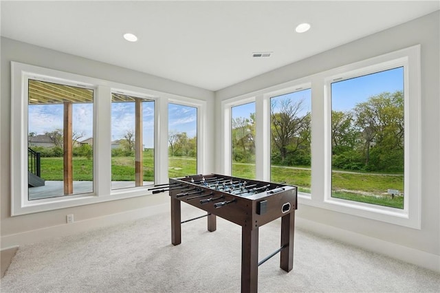 1510 NW 106th Ter, Kansas City, MO 64155 - playroom with baseboards, visible vents, light carpet, and a healthy amount of sunlight