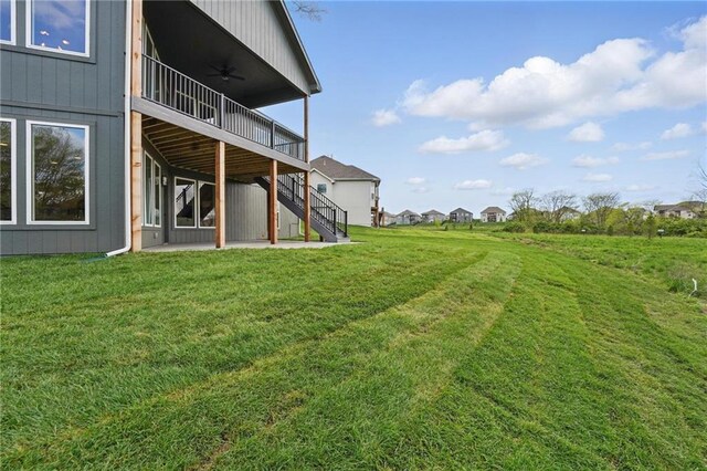 1510 NW 106th Ter, Kansas City, MO 64155 - view of yard with a patio, a ceiling fan, a wooden deck, and stairway