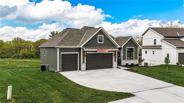 1510 NW 106th Ter, Kansas City, MO 64155 - view of front of property with a front lawn, stone siding, an attached garage, central air condition unit, and driveway