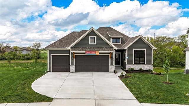 1510 NW 106th Ter, Kansas City, MO 64155 - craftsman-style house featuring a garage, stone siding, driveway, and a front yard