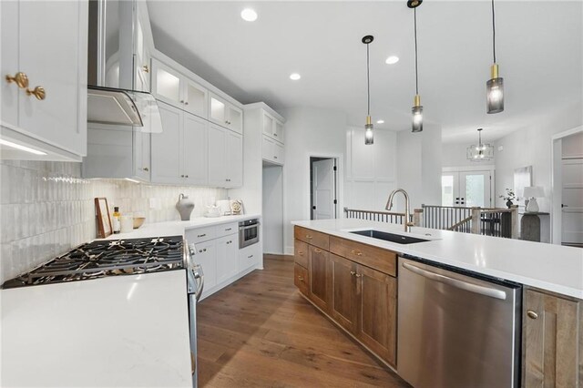 1510 NW 106th Ter, Kansas City, MO 64155 - kitchen with backsplash, a sink, light countertops, glass insert cabinets, and stainless steel appliances