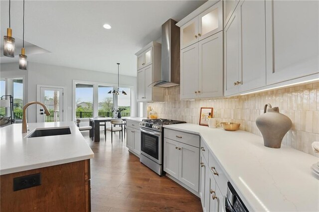 1510 NW 106th Ter, Kansas City, MO 64155 - kitchen featuring wall chimney range hood, backsplash, gas range, pendant lighting, and a sink