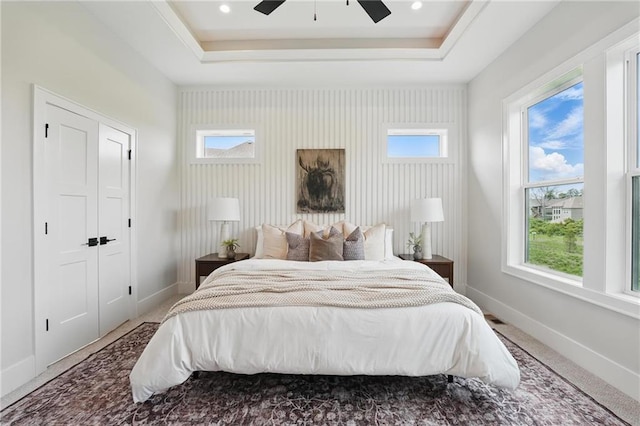 1510 NW 106th Ter, Kansas City, MO 64155 - bedroom featuring a raised ceiling, multiple windows, and baseboards